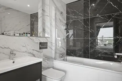 a black and white bathroom with a sink and a toilet at Apartment Balcony with Expansive Sea Views Parking in Newquay