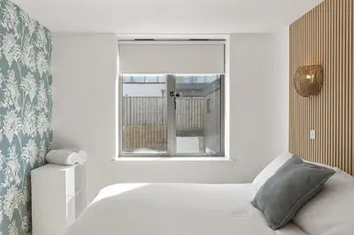 a bedroom with a bed and a window at Apartment Balcony with Expansive Sea Views Parking in Newquay
