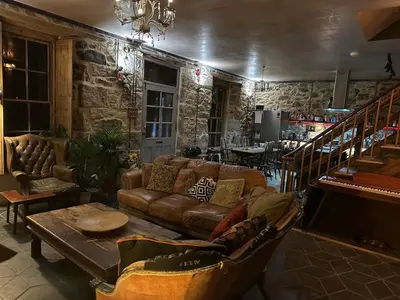 a living room with a couch and a table at Tin Miners Captain Georgian hs, parking, Logburner in Camborne
