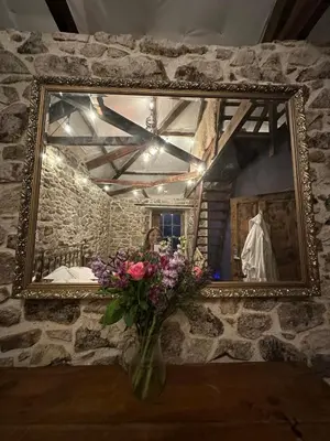 a vase of flowers in front of a mirror at Tin Miners Captain Georgian hs, parking, Logburner in Camborne