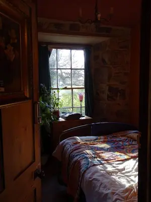 a bedroom with a bed and a window at Tin Miners Captain Georgian hs, parking, Logburner in Camborne