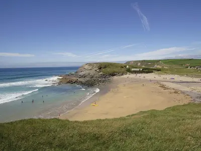 a group of people on a beach near the ocean at Little Content Farm Cottage in Cury