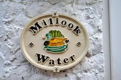 a sign on a wall with a duck on it at Finest Retreats - Millook Water in Poundstock
