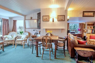 a living room with a table and chairs at Finest Retreats - Millook Water in Poundstock