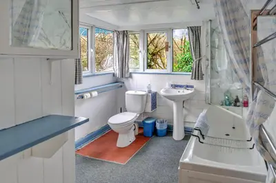 a bathroom with a toilet and a sink and a shower at Finest Retreats - Millook Water in Poundstock