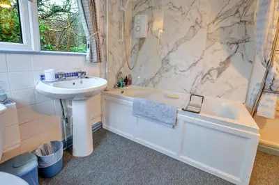 a bathroom with a sink and a toilet and a tub and a sink at Finest Retreats - Millook Water in Poundstock