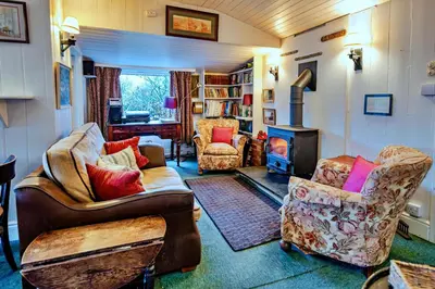 a living room with two couches and a fireplace at Finest Retreats - Millook Water in Poundstock