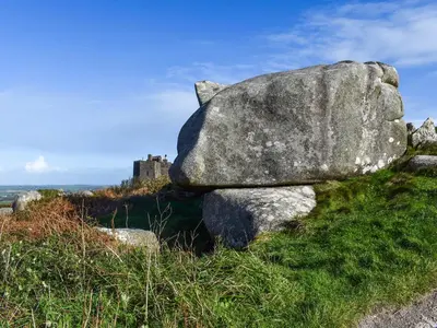 a rock on a hill with a castle in the background at Number 8 in Camborne