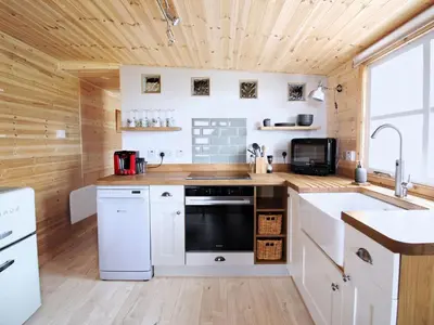a kitchen with white appliances and a wooden ceiling at Holiday Home für 1 Personen - 1 Kind ca- 33 m² in Ludgvan- Cornwall by Interhome in Ludgvan