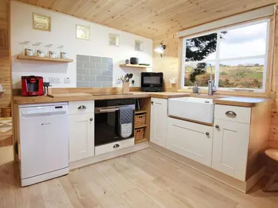 a kitchen with white cabinets and a large window at Holiday Home für 1 Personen - 1 Kind ca- 33 m² in Ludgvan- Cornwall by Interhome in Ludgvan