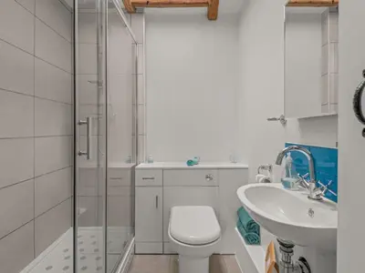 a bathroom with a shower and a toilet and a sink at Holiday Home Idyllisches Landhaus Rosemary by Interhome in Liskeard