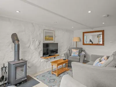 a living room with a couch and a fireplace at Holiday Home Idyllisches-haustierfreundliches Landhaus Lavender by Interhome in Liskeard