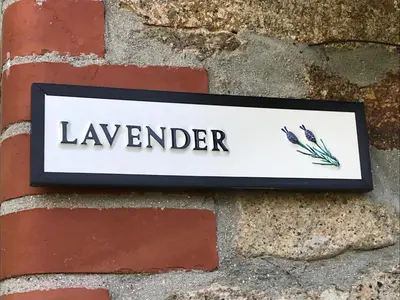 a sign on a brick wall with the word lavender at Holiday Home Idyllisches-haustierfreundliches Landhaus Lavender by Interhome in Liskeard