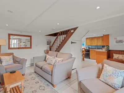 a living room with a couch and chairs and a kitchen at Holiday Home Idyllisches-haustierfreundliches Landhaus Lavender by Interhome in Liskeard
