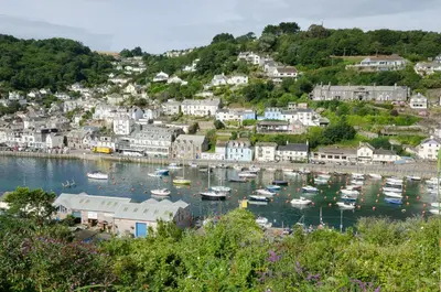 a small harbor with boats in the water at Russell Court 2 - Beautifully furnished modern apartment with parking and views over Looe river and town in Looe