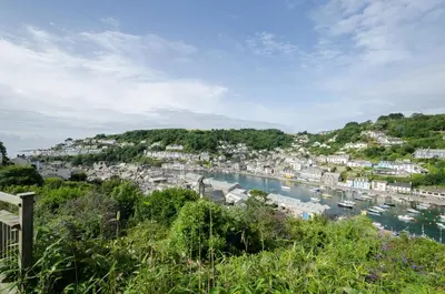 a view of a harbor with boats in the water at Russell Court 2 - Beautifully furnished modern apartment with parking and views over Looe river and town in Looe