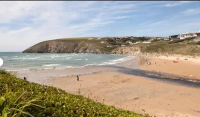a beach with a group of people on the sand at Cosy three bedroom holiday home in Parkdean Newquay in Newquay