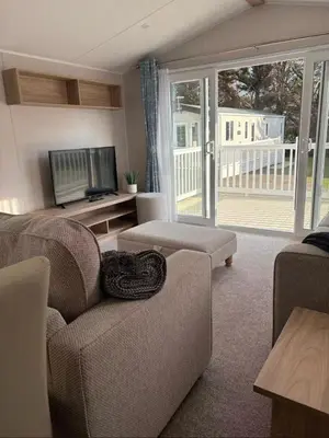 a living room with a couch and a television at Cosy three bedroom holiday home in Parkdean Newquay in Newquay