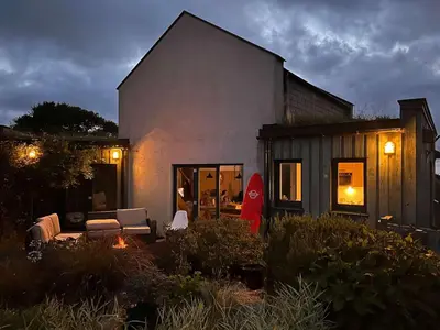 a house with a couch and chairs in a yard at Beach Life Cabin Vibes Ocean Views nr Bude in Bude