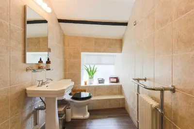 a bathroom with a sink and a toilet and a tub at Listed Fisherman's Cottage Mevagissey Sea Views in Mevagissey
