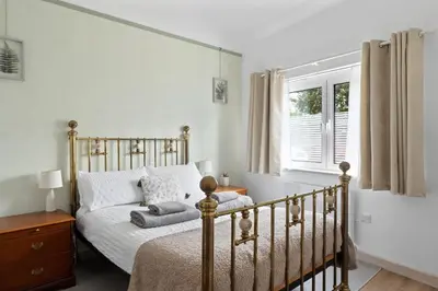 a bedroom with a bed and a window at Scandi Style Apartment in Central Falmouth in Falmouth