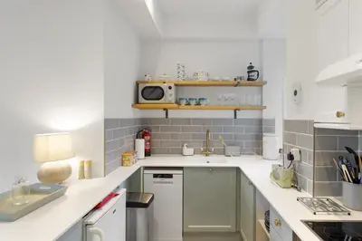 a kitchen with a sink and a microwave at Cosy Cottage nr Bodmin Moor Private Parking in Helland