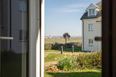 a view of a house from a window at Stylish Apartment Garden with Beautiful Sea Views in Newquay
