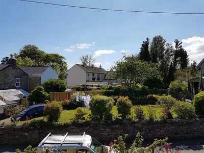 a white van parked in a yard with a garden at Homely Cottage & Garden nr Fowey Private Parking in Par