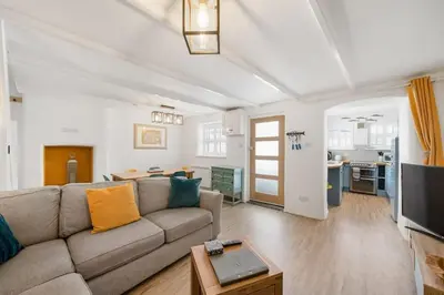 a living room with a couch and a table at Beautiful Cottage Minutes from Mevagissey Harbour in Mevagissey