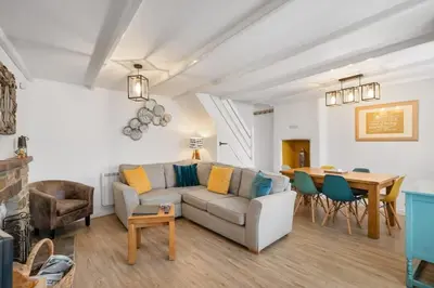 a living room with a couch and a table at Beautiful Cottage Minutes from Mevagissey Harbour in Mevagissey