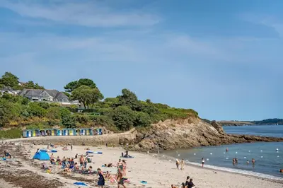 a group of people on a beach near the water at Stylish Apartment in Falmouth nr Seafront in Falmouth