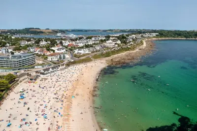 an overhead view of a beach with people and umbrellas at Stylish Apartment in Falmouth nr Seafront in Falmouth