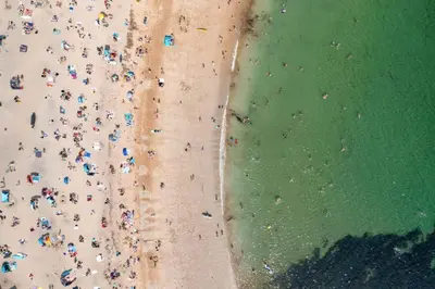 an overhead view of a beach with a crowd of people at Stylish Apartment in Falmouth nr Seafront in Falmouth