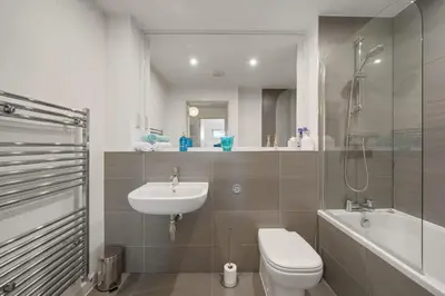 a bathroom with a sink and a toilet and a shower at Modern Mews Home with Sea Views Private Parking in Newquay
