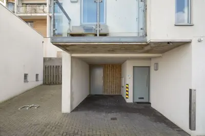 an empty hallway of a building with a balcony at Modern Mews Home with Sea Views Private Parking in Newquay
