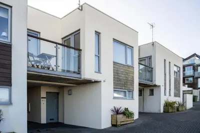 a white house with a balcony at Modern Home with Sea Views Newquay in Newquay