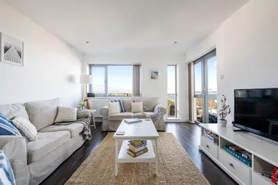 a living room with a couch and a tv at Modern Home with Sea Views Newquay in Newquay