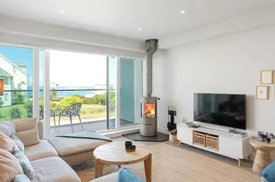 a living room with a couch and a tv at Contemporary Townhouse with Sea Views & Parking in Newquay