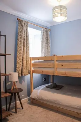 a bedroom with a bunk bed and a window at Smugglers Cottage in Penryn Nr Falmouth in Penryn