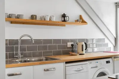 a kitchen with a sink and a dishwasher at Beach-Style Flat 2 Min Walk to Tolcarne Beach in Newquay