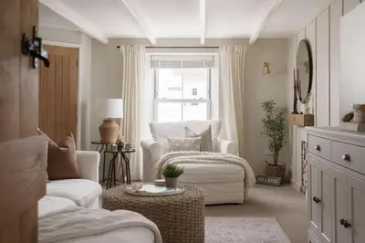 a living room with a white couch and a window at Luxury Cottage with Parking Minutes to Beach and Restaurants in Porthleven