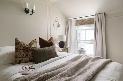 a bedroom with a bed with glasses on it at Luxury Cottage with Parking Minutes to Beach and Restaurants in Porthleven