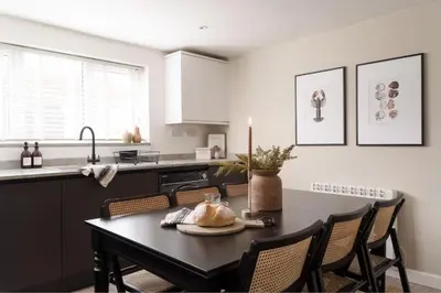 a kitchen with a table with a candle on it at Luxury Cottage with Parking Minutes to Beach and Restaurants in Porthleven