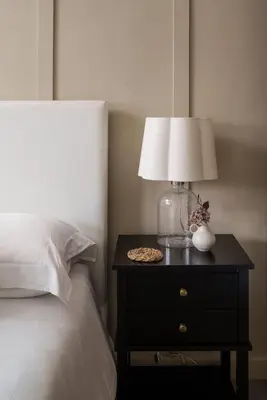 a lamp on a night stand next to a bed at Luxury Cottage with Parking Minutes to Beach and Restaurants in Porthleven
