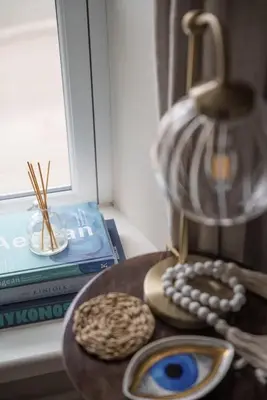 a table with two cookies and a vase and a book at Luxury Cottage with Parking Minutes to Beach and Restaurants in Porthleven