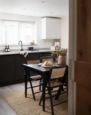 a kitchen with a table with chairs and a sink at Luxury Cottage with Parking Minutes to Beach and Restaurants in Porthleven