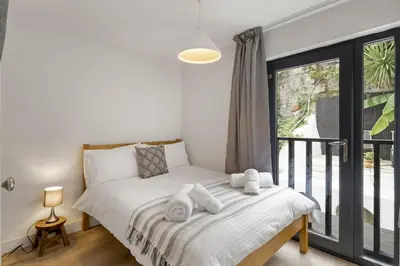 a bedroom with a bed with towels on it at Modern Townhouse in Central Falmouth Nr Seafront in Falmouth
