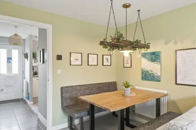 a dining room with a wooden table and chairs at Stylish Home with Private Parking & Garden in Newquay
