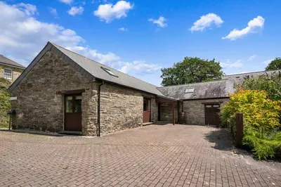 an old stone barn with a brick driveway at Swift Barn Lambest Farm Menheniot Cornwall in Menheniot