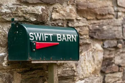 a green mailbox with the words swift barnan on it at Swift Barn Lambest Farm Menheniot Cornwall in Menheniot
